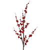 A single stem of artificial Japonica blossoms with red flowers and yellow stamens against a white background.