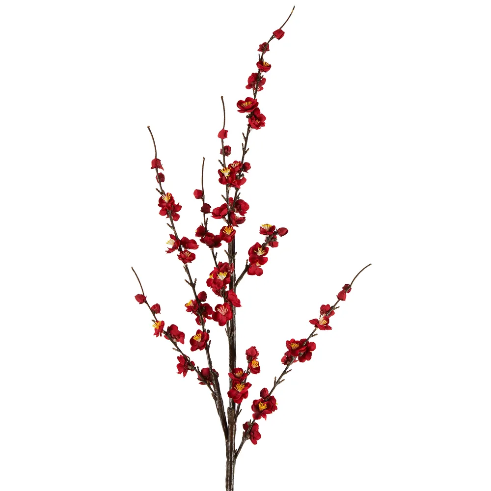 A single stem of artificial Japonica blossoms with red flowers and yellow stamens against a white background.