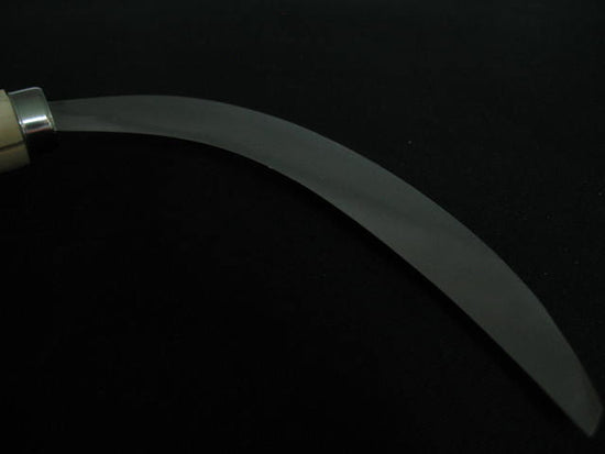 Sickle with a metallic handle on a black background