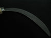 Sickle with a metallic handle on a black background