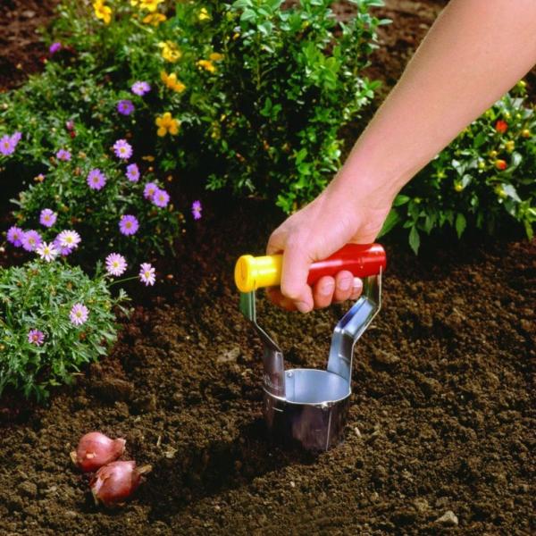 Insert the WOLF GARTEN Automatic Bulb Planter into the ground